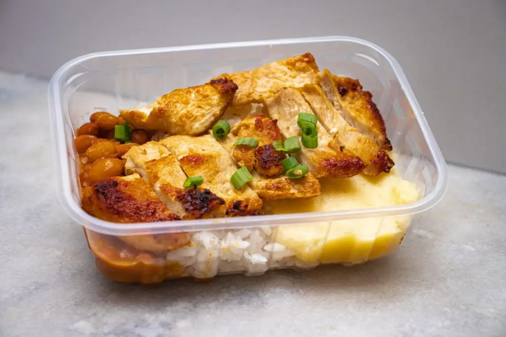 Several high protein meal prep lunches portioned into glass containers on a counter