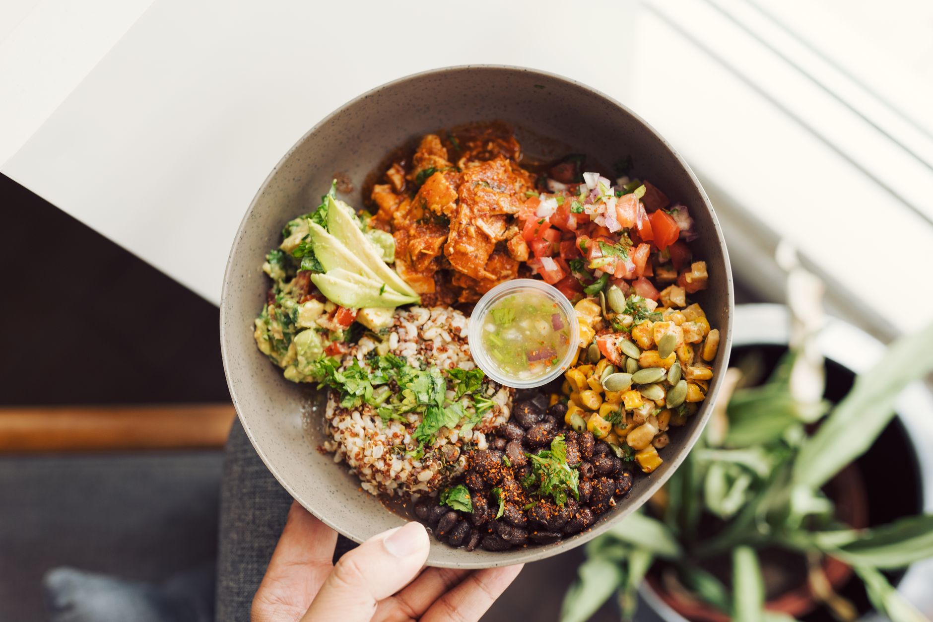 A vegan buddha bowl with grains, roasted vegetables, and crispy tofu