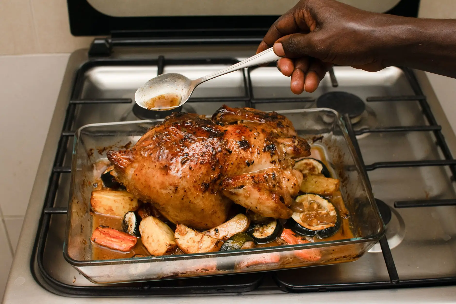 Sheet pan of roasted chicken sausage and vegetables ready to portion into lunches