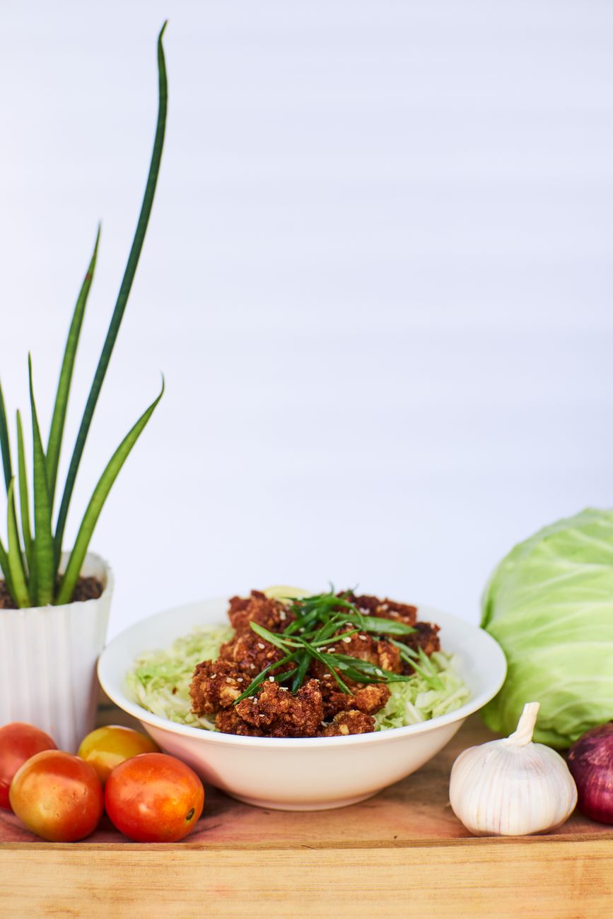 Egg roll in a bowl with ground pork and cabbage in a meal prep container