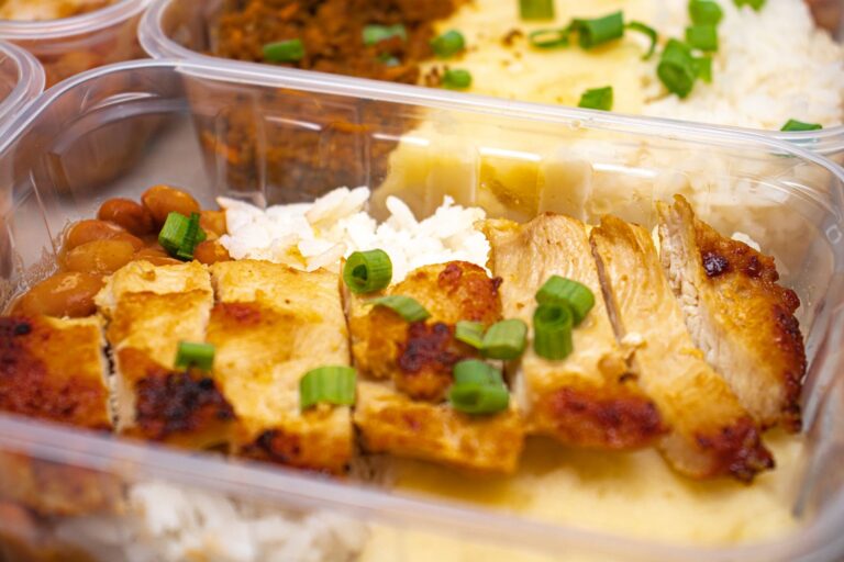 meal prep for weight loss in glass containers with chicken, rice and roasted vegetables