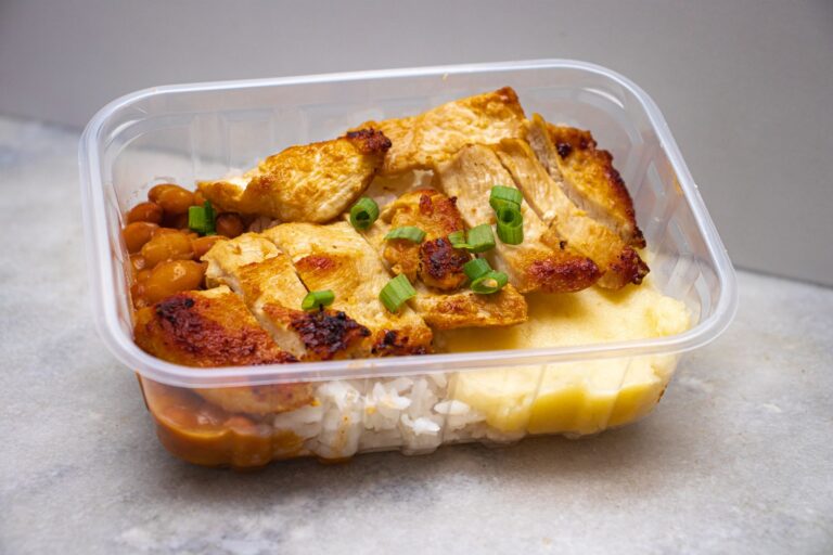 cheap dinner ideas portioned into a meal prep container with chicken and rice
