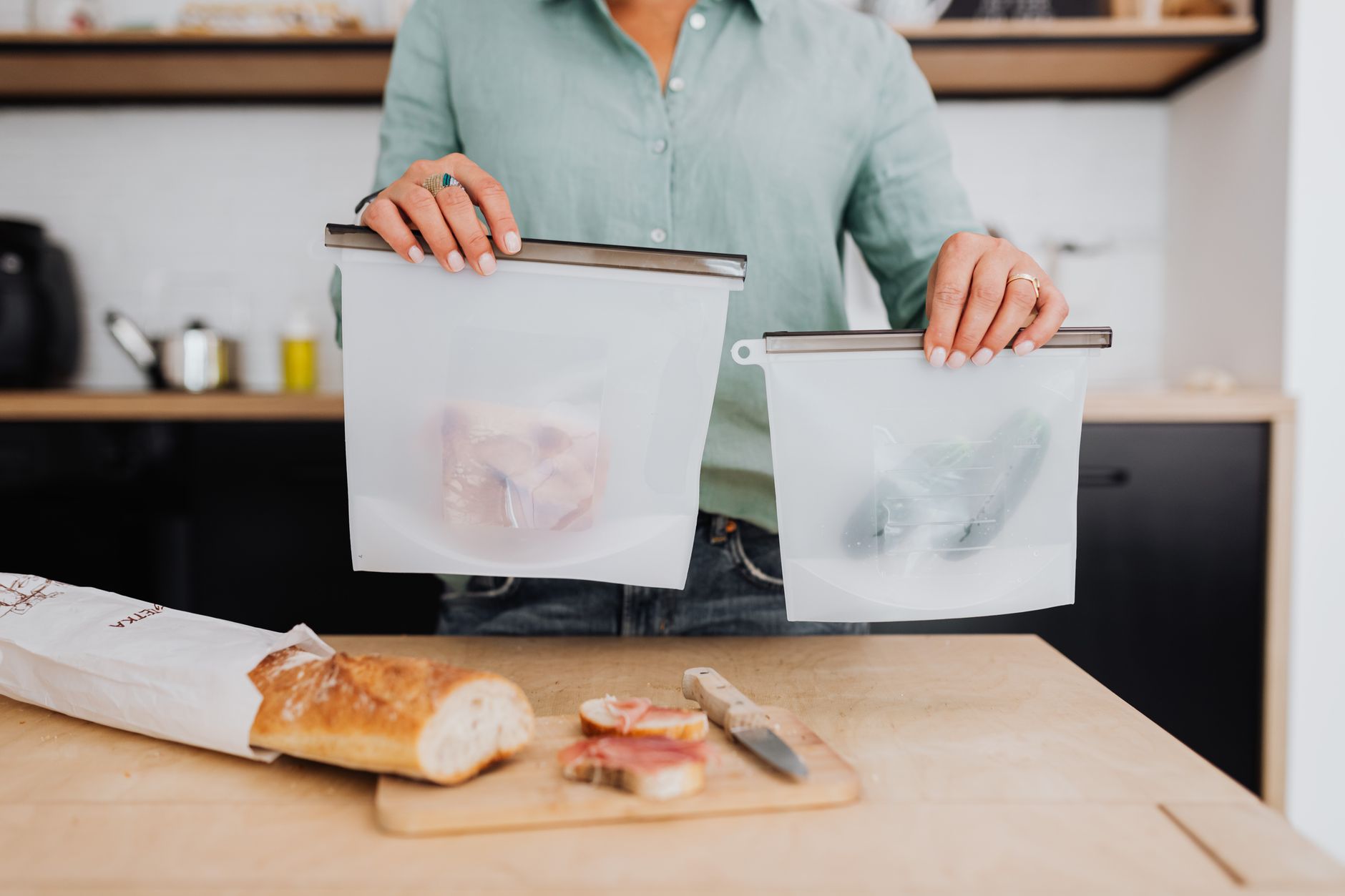 labeled freezer bags of make-ahead crockpot dinner ideas stacked flat in the freezer