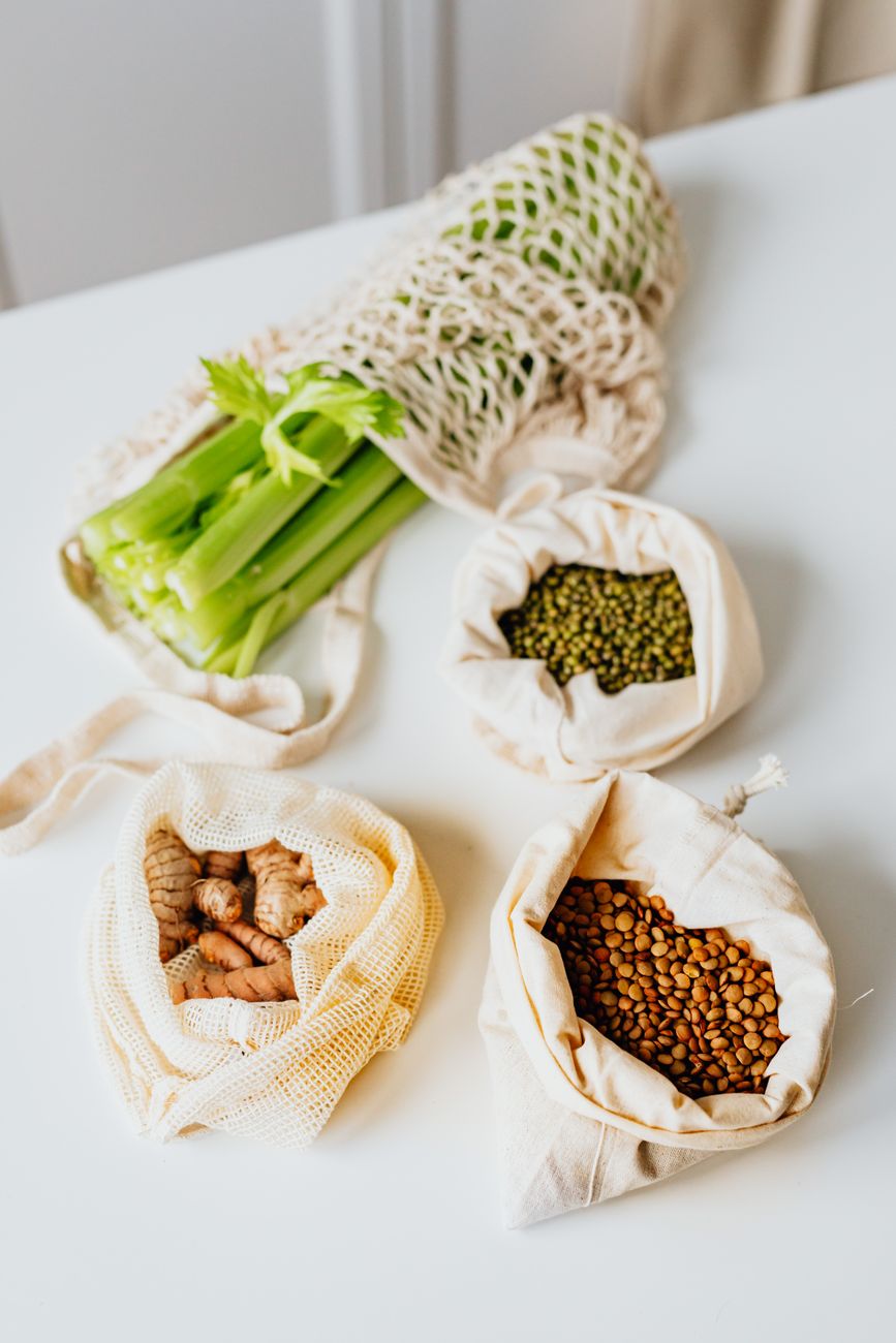 fresh vegetables and grains laid out for easy plant based meal prep on a kitchen counter