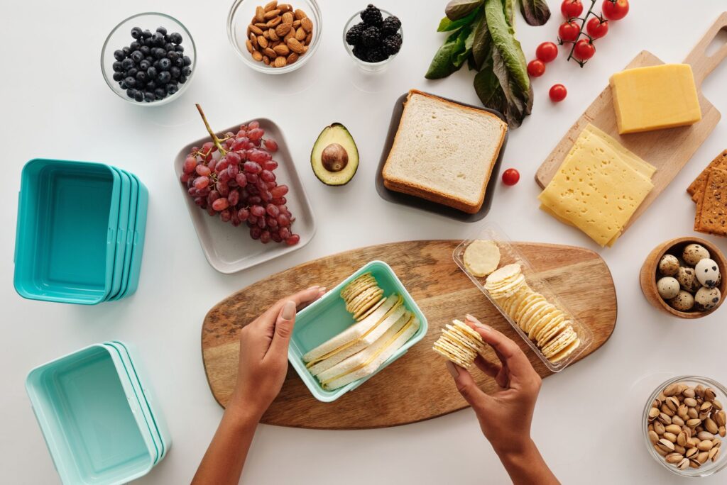 quick no-cook lunch ideas prepped in glass meal prep containers with chicken, chickpeas and vegetables