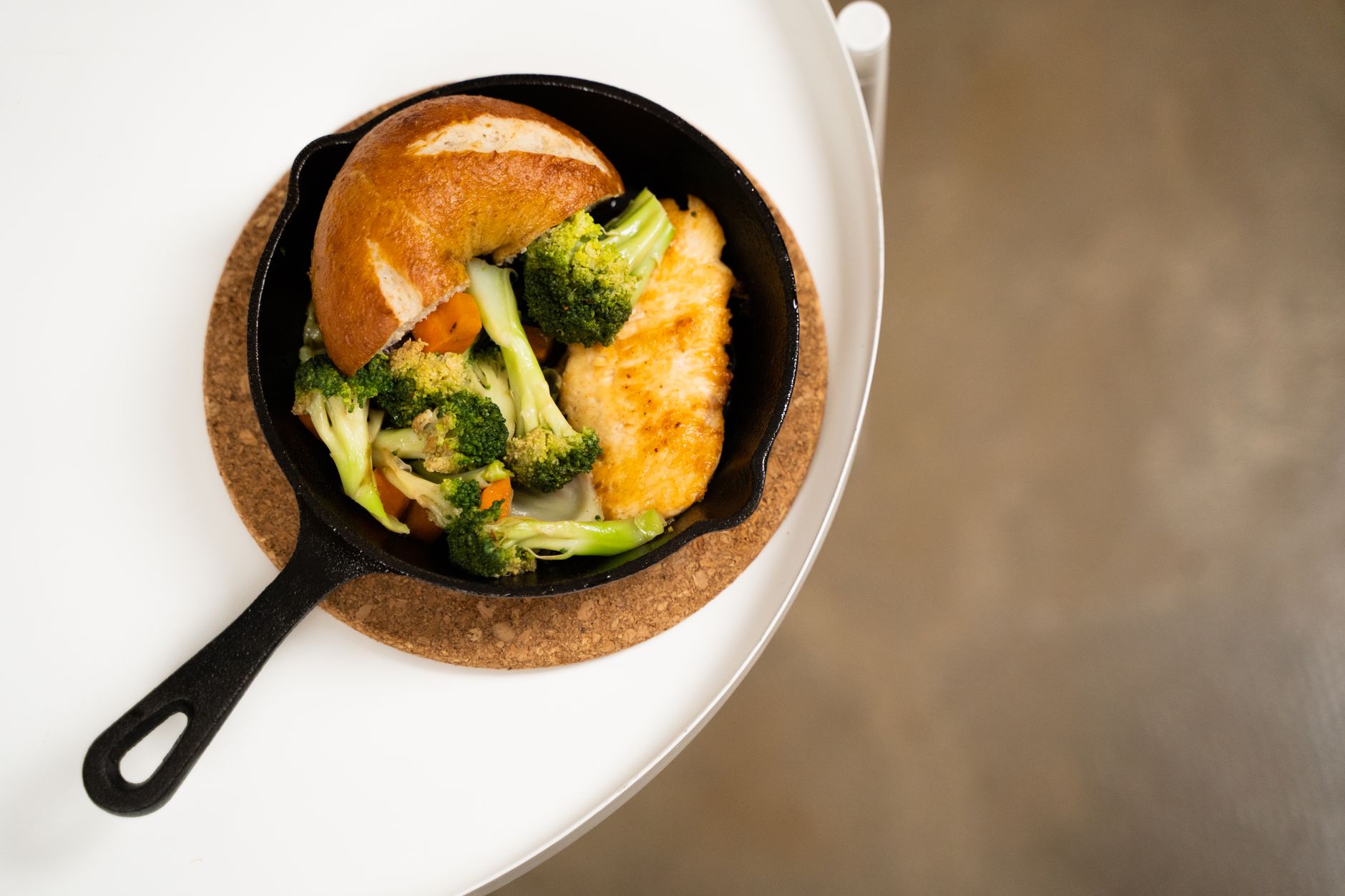 searing high protein chicken breast in a cast iron skillet for meal prep